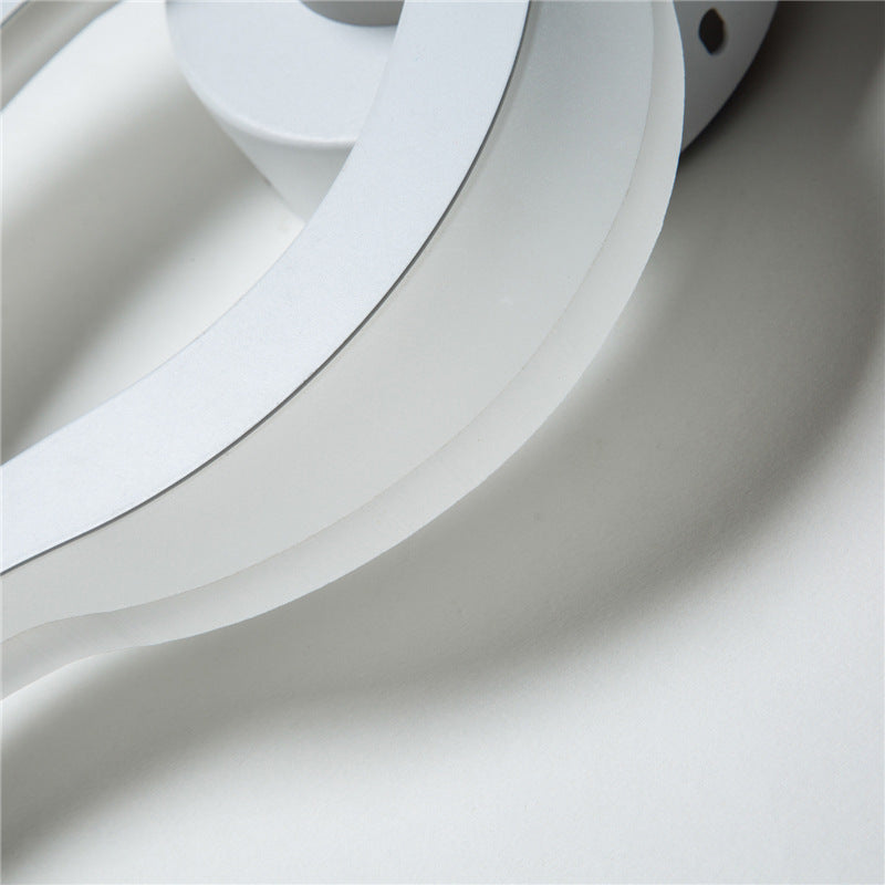 Close-up of the white acrylic curve of the flame wall sconce