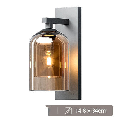 Amber glass wall sconce lit, with its size marked on the image
