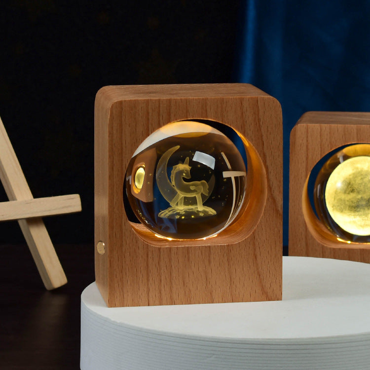 Crystal ball with a carousel engraving lit inside a square wooden frame
