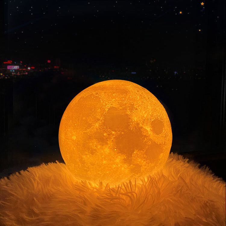 3D moon table lamp glowing orange on a fluffy rug