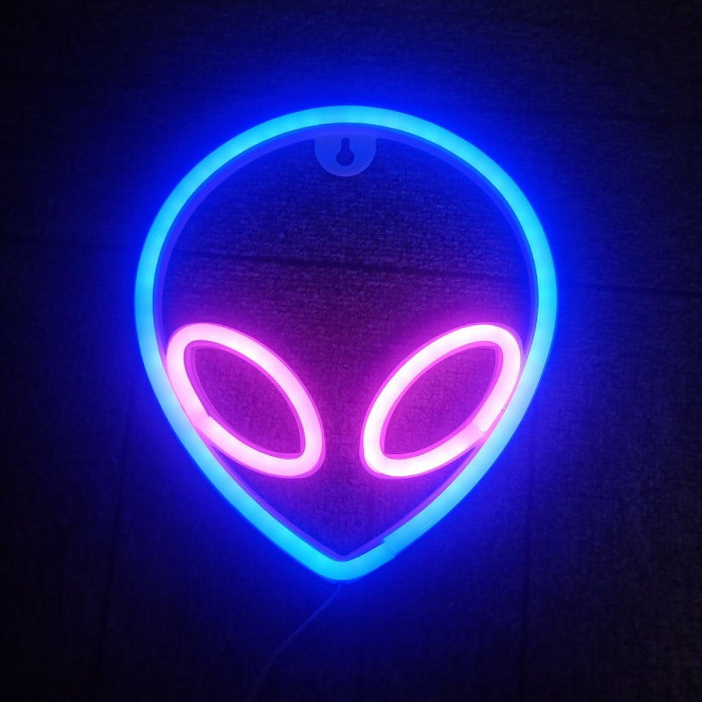 Alien head neon wall sign lit in blue with purple eyes
