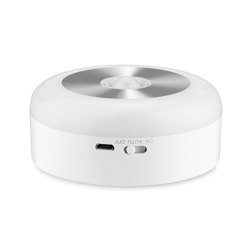 Round night light seen from the side, showing the charging port and switch