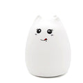 White silicone cat night light with a blushing face, plain background