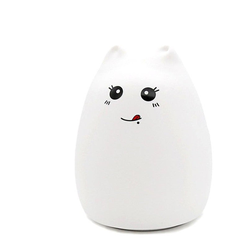 White silicone cat night light with a blushing face, plain background
