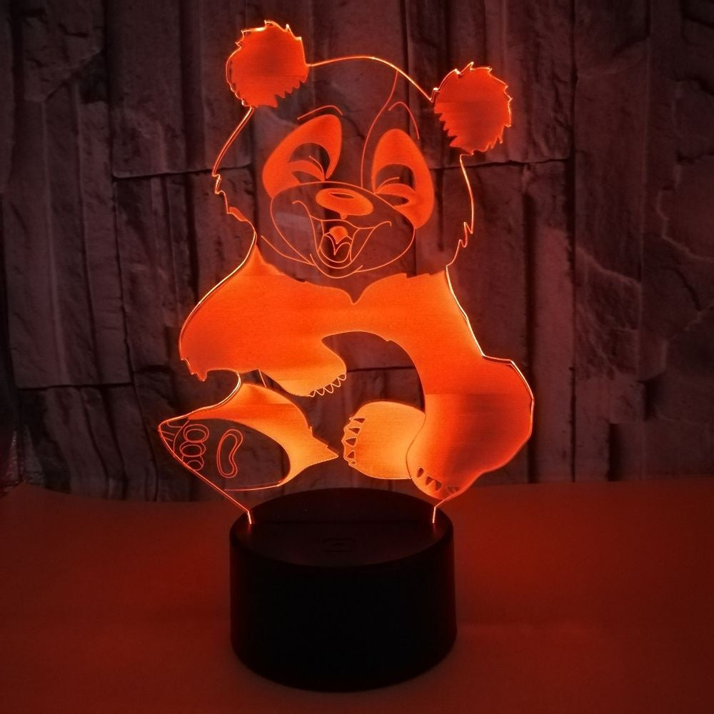 Acrylic 3D panda night light lit orange on a black base