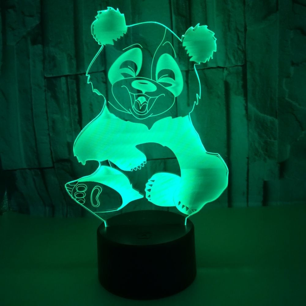 Acrylic 3D panda night light lit green on a black base