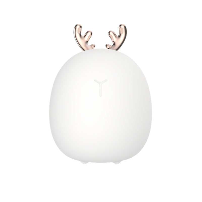 White silicone night light with rose gold antlers, plain background