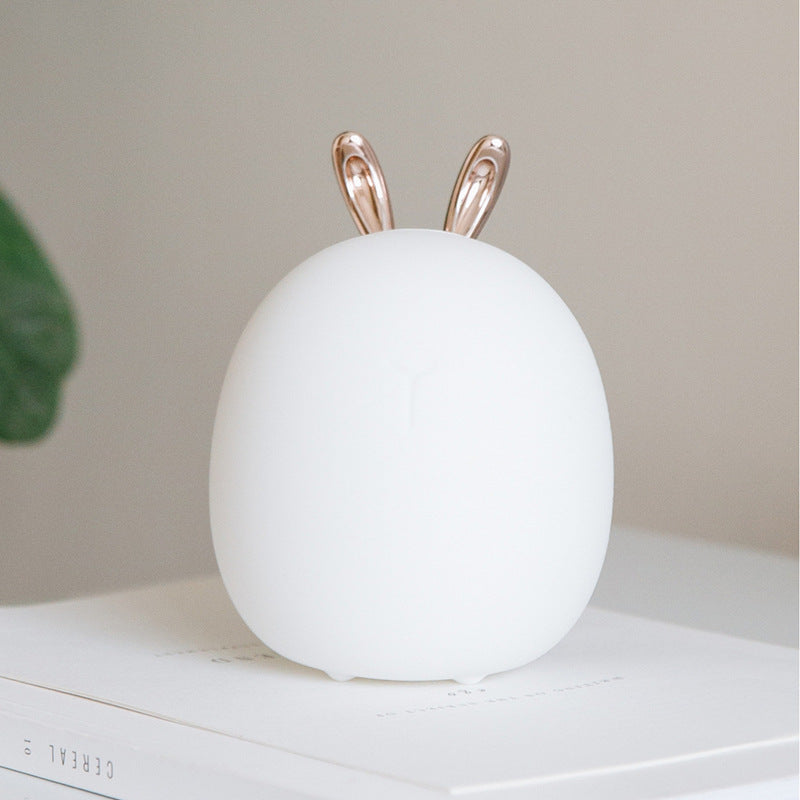 White silicone rabbit-ear night light on a white surface