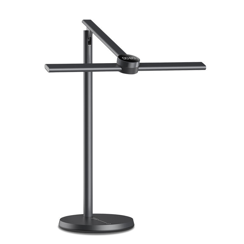 Black reading lamp with a horizontal head on a round base, plain background