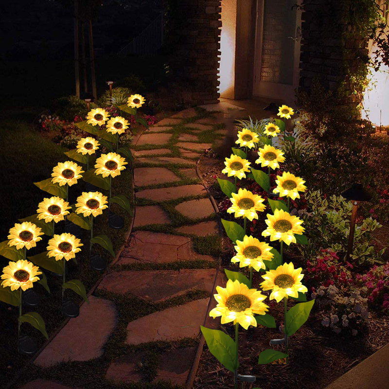Sunflower solar lights lining a stone garden path at night