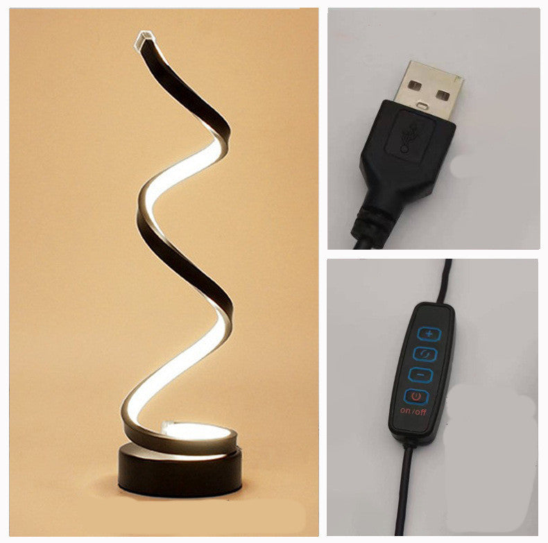 Spiral LED lamp with a black base shown with its USB cable and inline dimmer