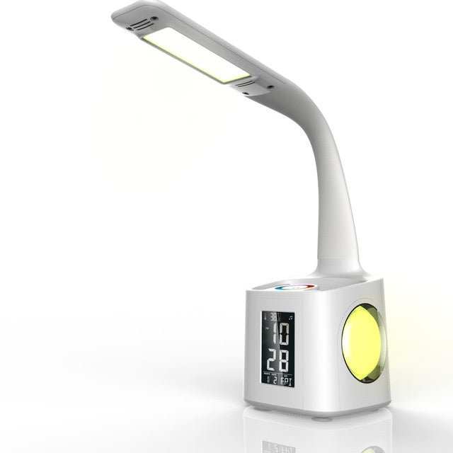 White desk lamp with pen holder and LCD clock, plain background