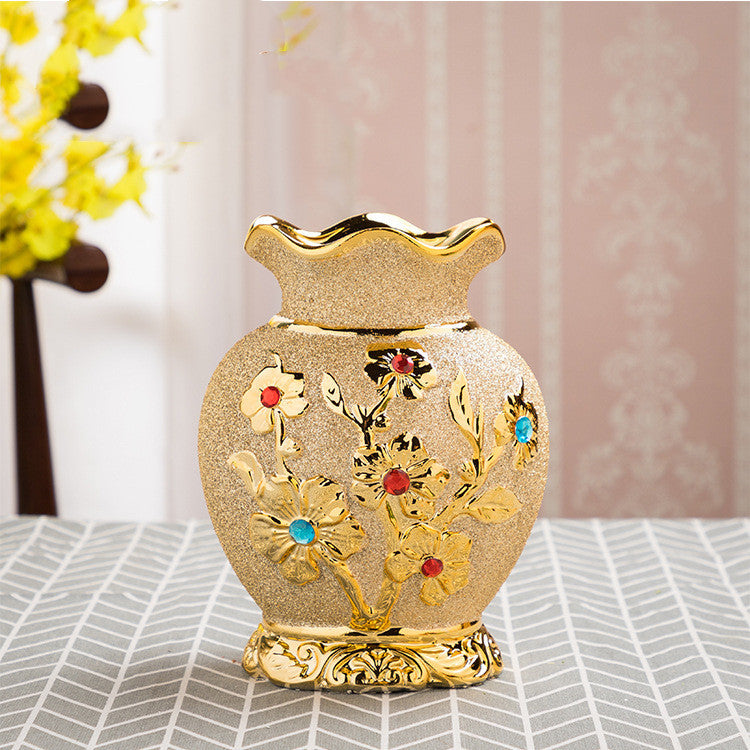 Cream ceramic vase with raised gold floral pattern and coloured stones, fluted rim