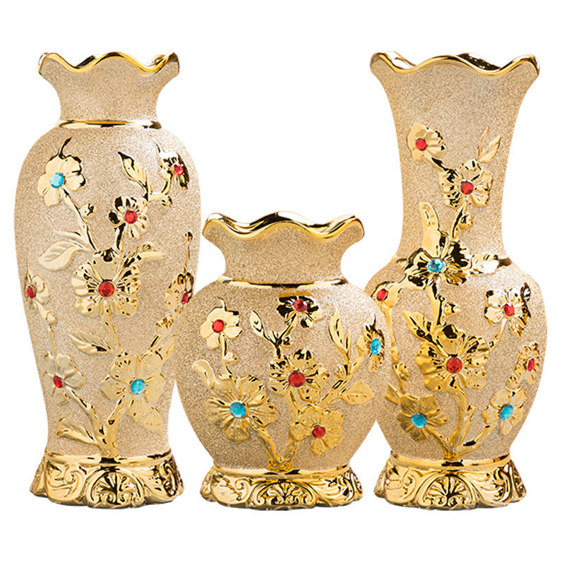 Three jewelled ceramic vases in three sizes, plain background