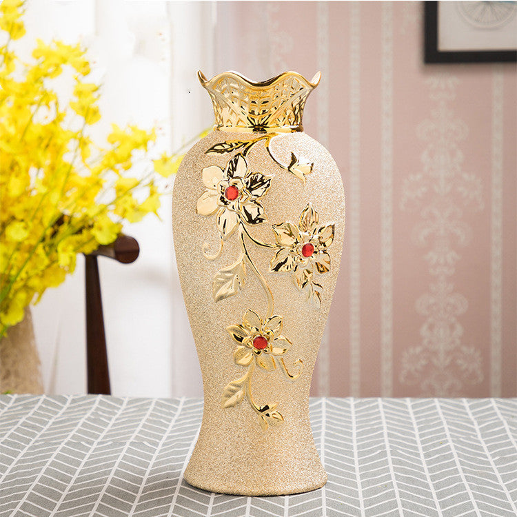 Tall fluted ceramic vase with a gold leaf and blossom relief
