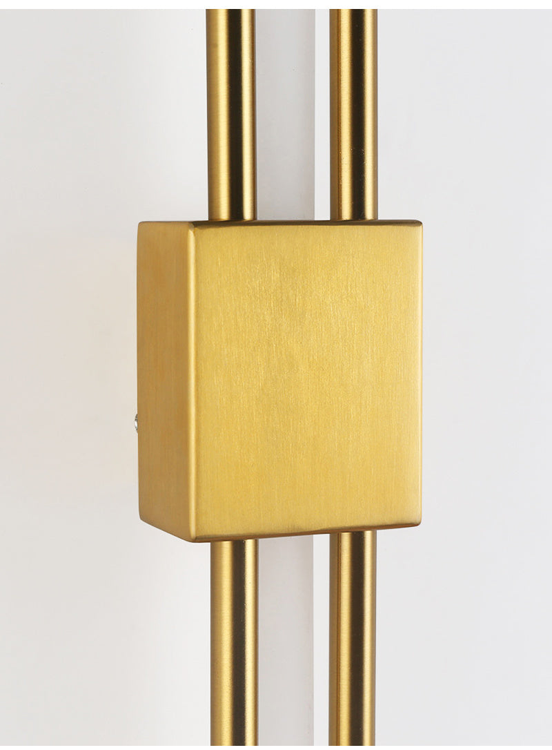 Close-up of the brushed gold mounting block on the wall sconce