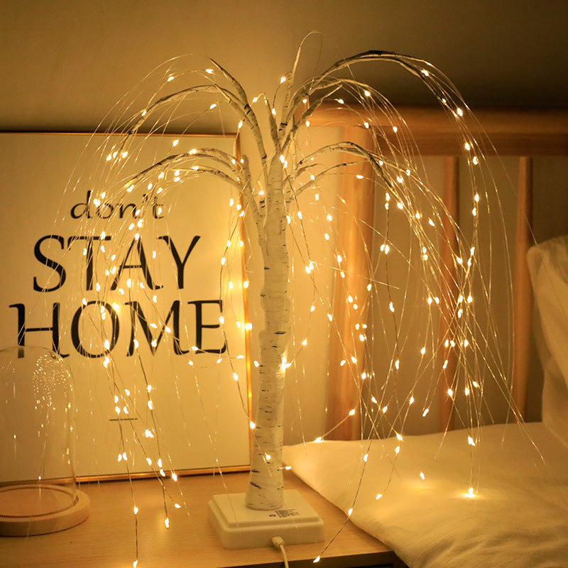 LED willow tree light lit warm in a bedroom corner